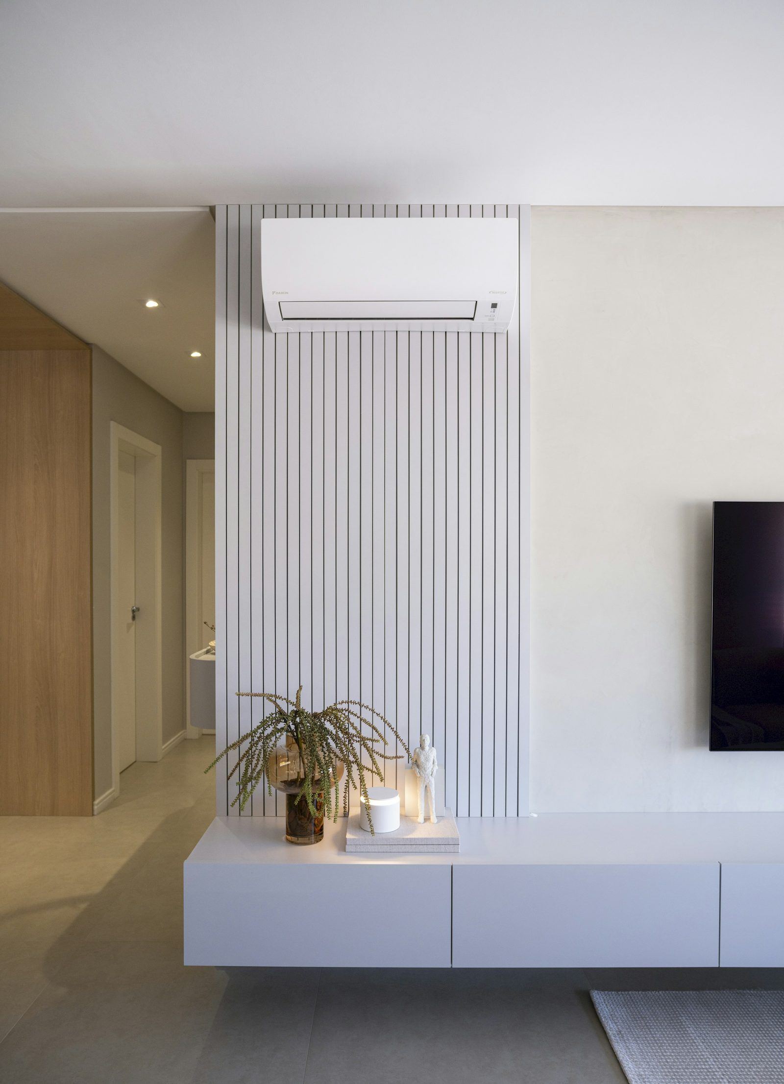 A living room with a wall-mounted air conditioning unit